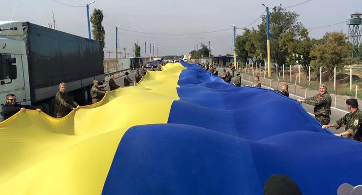 На админгранице с Крымом развернули 26-метровый украинский флаг