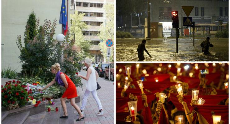 День в фото: Цветы у посольства Франции, потоп в Гданьске и закрытие фестиваля в Испании